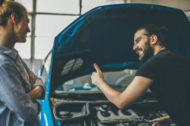 Mechanic inspecting a car engine